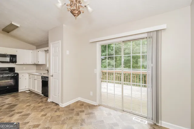a kitchen with a stove a refrigerator and a sink