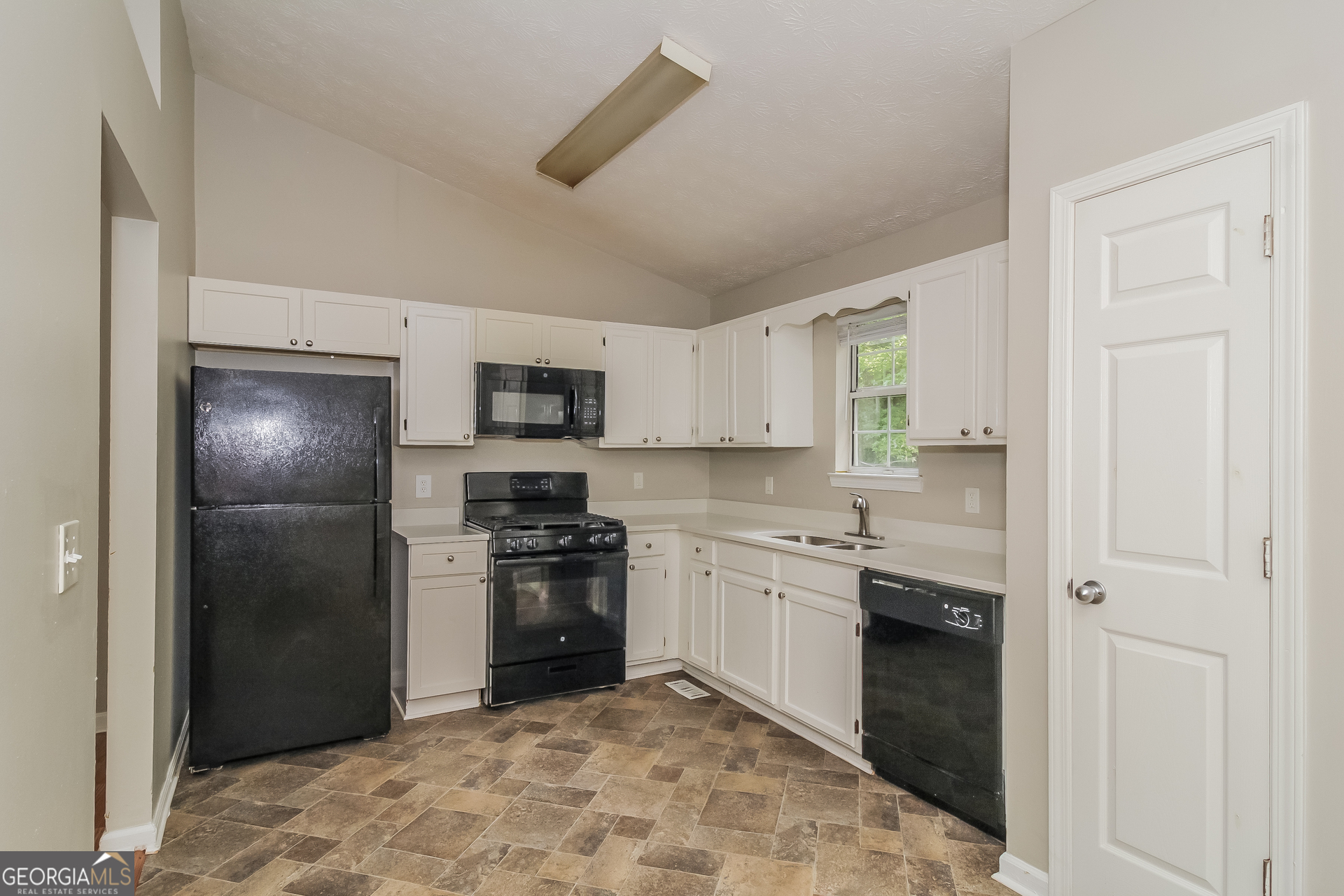 124 Emerald Pines Drive Dallas, GA 30157 - Photo 6 of 17 a kitchen with stainless steel appliances granite countertop a refrigerator and a sink