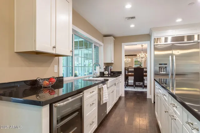 a view of a dining room with furniture and chandelier