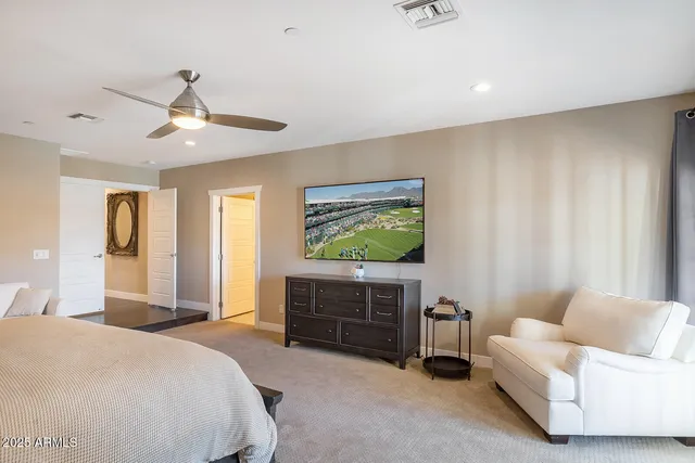 a bedroom with a bed and a ceiling fan