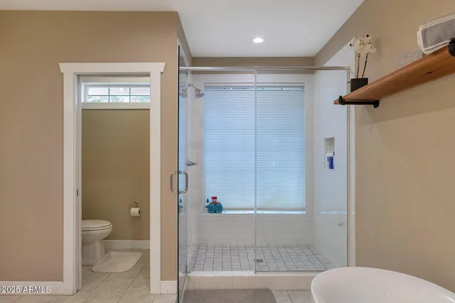 a living room with furniture and large windows