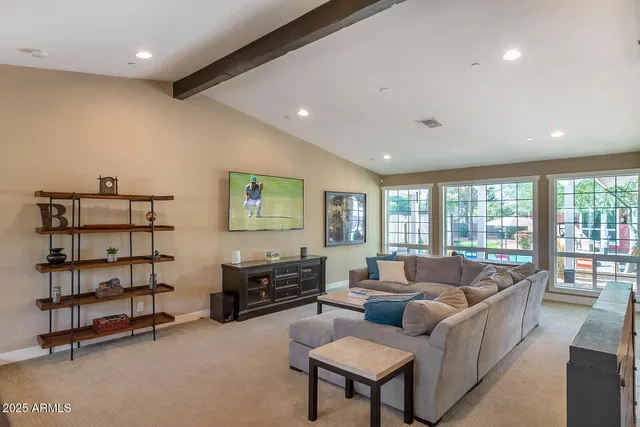 a living room with furniture pool table and a large window