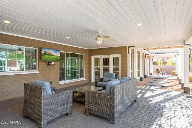 a bathroom with a granite countertop sink a toilet and a mirror