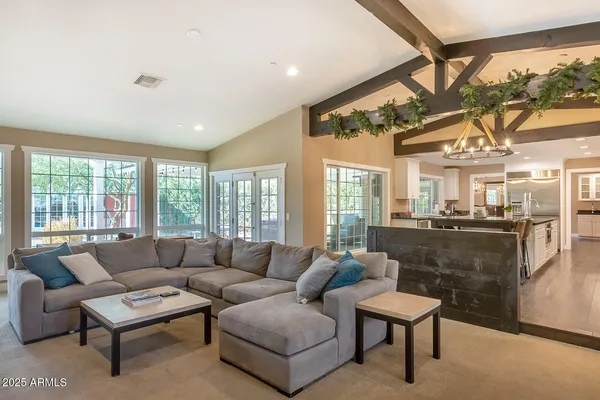 a living room with furniture pool table and a large window