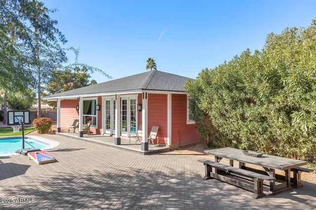 a kitchen with a refrigerator and white cabinets