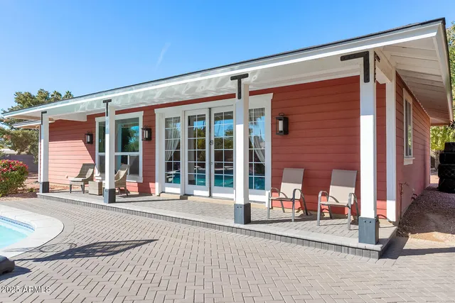a view of a patio with a table and chairs under an umbrella