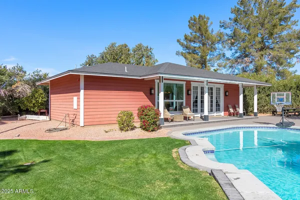 a view of a house with floor to ceiling windows and a table