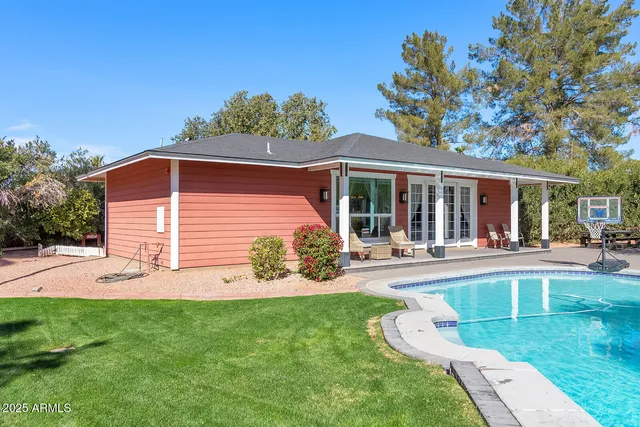 a view of a house with floor to ceiling windows and a table