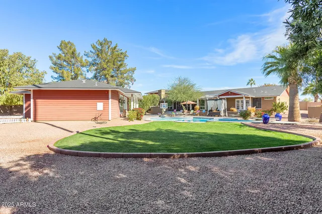 a table and chairs in patio of a house