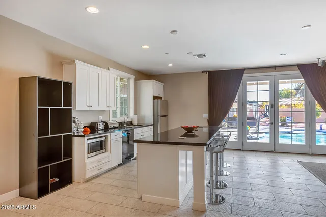 a view of a patio with table and chairs with wooden fence and plants