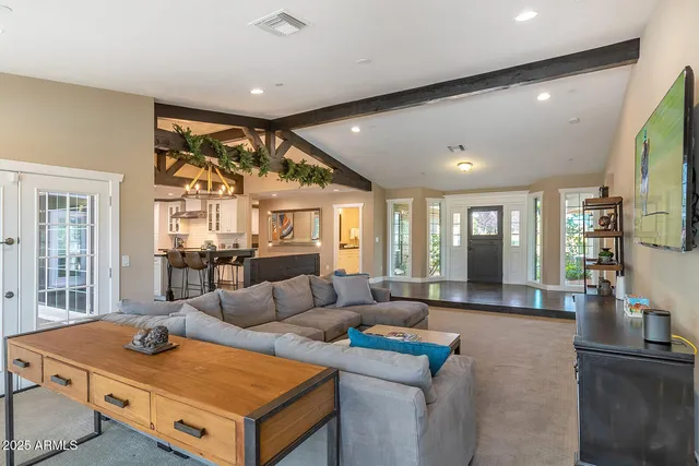 a kitchen with stainless steel appliances a table and chairs