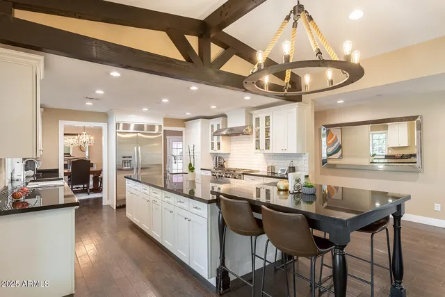 a large kitchen with granite countertop lots of counter space and a sink