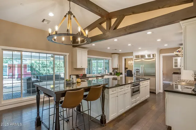 a kitchen with stainless steel appliances cabinets a large window and a sink