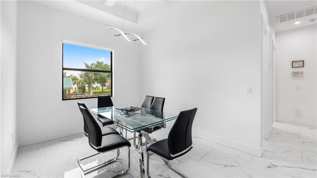 2998 52nd Street Southwest Naples, FL 34116 - Photo 14 of 44 Dining room with light marble finish flooring and baseboards