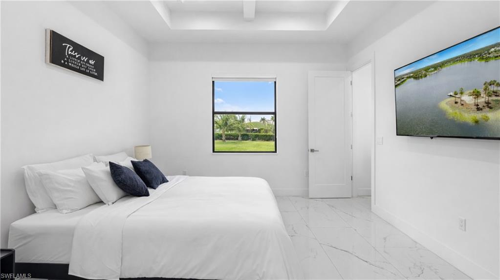 2998 52nd Street Southwest Naples, FL 34116 - Photo 15 of 44 Bedroom with light marble finish floors and baseboards