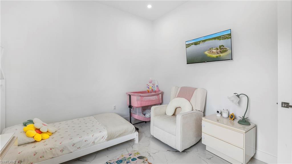 2998 52nd Street Southwest Naples, FL 34116 - Photo 16 of 44 Bedroom featuring marble look tile flooring and recessed lighting