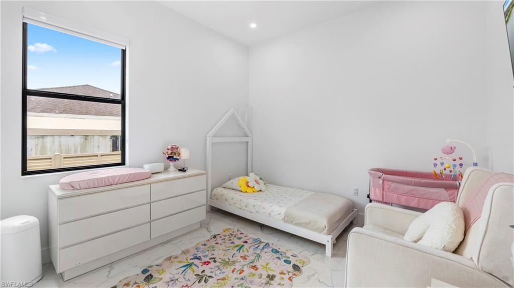 2998 52nd Street Southwest Naples, FL 34116 - Photo 17 of 44 Bedroom with light marble finish floors and recessed lighting