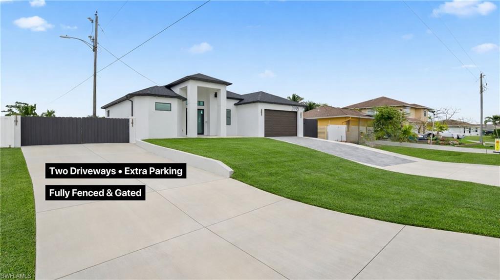 2998 52nd Street Southwest Naples, FL 34116 - Photo 2 of 44 Prairie-style house featuring driveway, stucco siding, and a garage