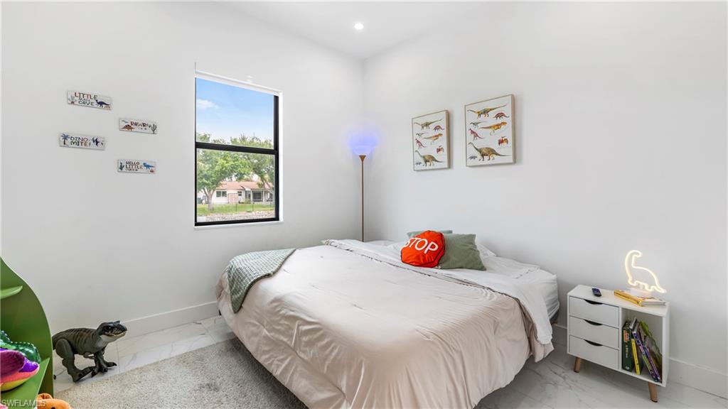 2998 52nd Street Southwest Naples, FL 34116 - Photo 19 of 44 Bedroom featuring baseboards