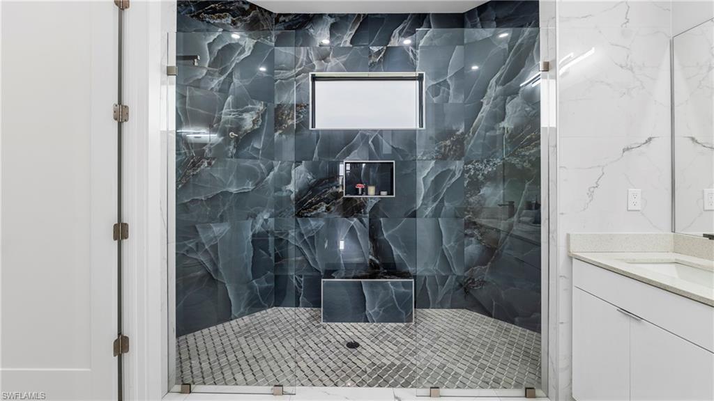 2998 52nd Street Southwest Naples, FL 34116 - Photo 21 of 44 Full bath featuring a marble finish shower and vanity
