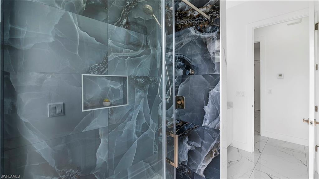 2998 52nd Street Southwest Naples, FL 34116 - Photo 26 of 44 Full bath featuring a marble finish shower and light marble finish flooring