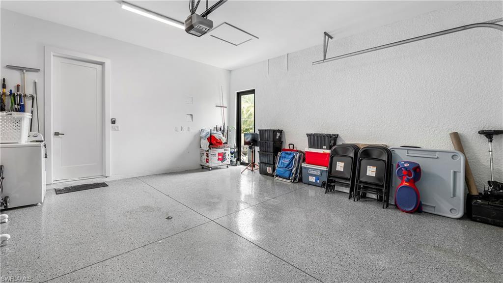 2998 52nd Street Southwest Naples, FL 34116 - Photo 27 of 44 Garage featuring washer / clothes dryer and a garage door opener