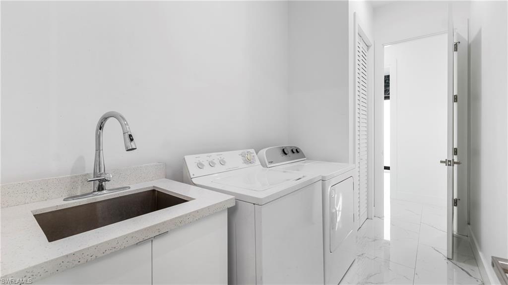 2998 52nd Street Southwest Naples, FL 34116 - Photo 28 of 44 Laundry room with light marble finish flooring and washer and dryer