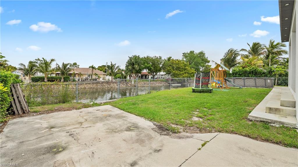 2998 52nd Street Southwest Naples, FL 34116 - Photo 34 of 44 Fenced yard with a water view, a patio area, and a playground