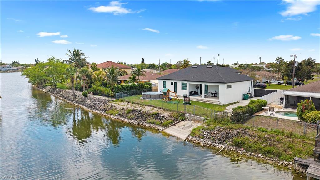 2998 52nd Street Southwest Naples, FL 34116 - Photo 4 of 44 Back of house featuring a fenced backyard, a patio, and a water view