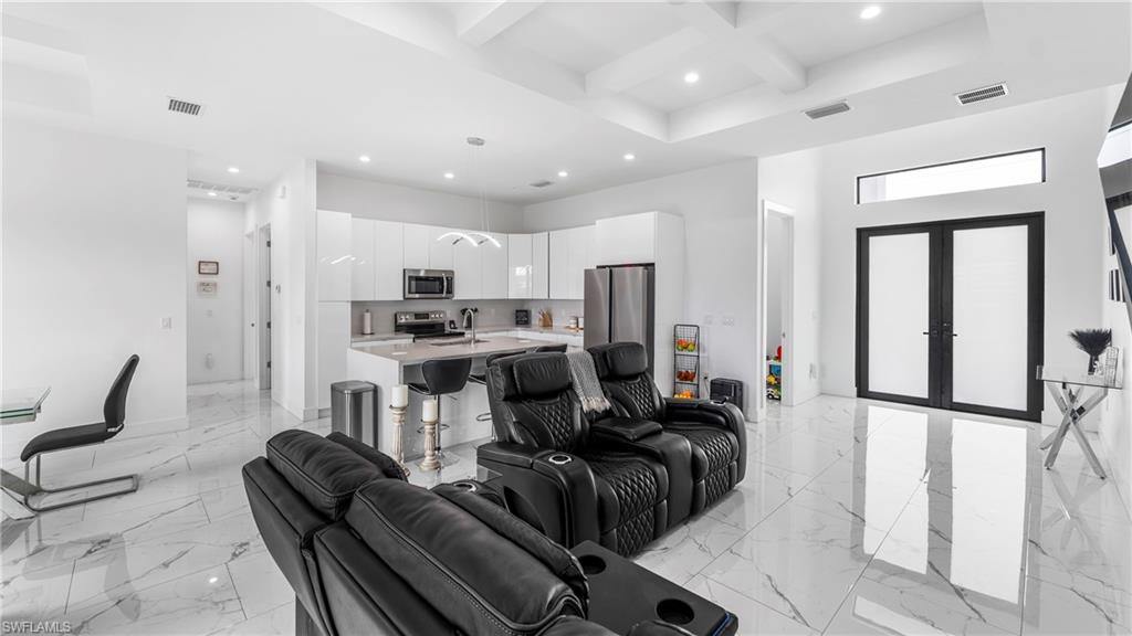 2998 52nd Street Southwest Naples, FL 34116 - Photo 6 of 44 Living room featuring coffered ceiling, french doors, and recessed lighting