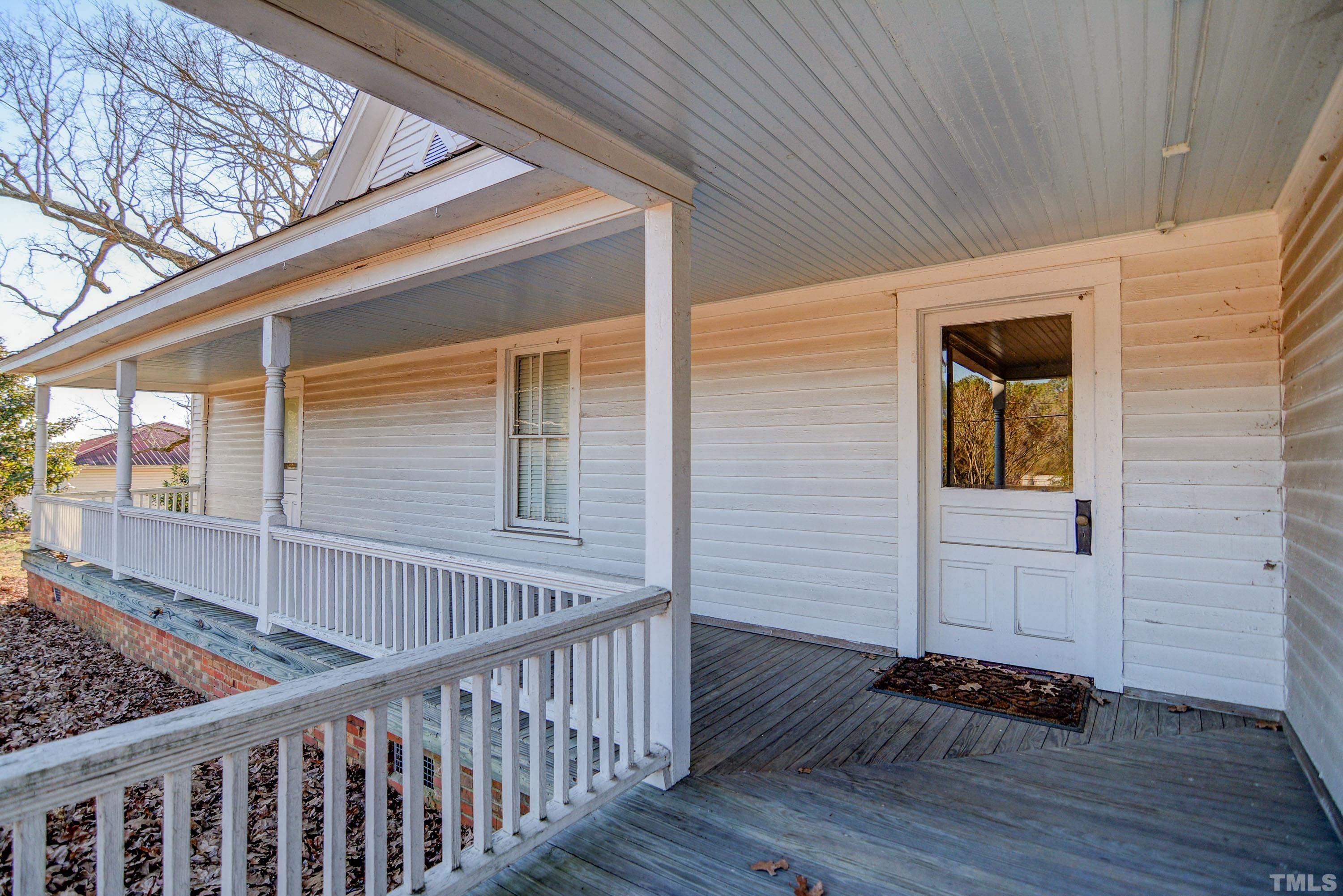 4740 Auburn Knightdale Road Raleigh, NC 27610 - Photo 11 of 23 a view of a porch with wooden floor and fence