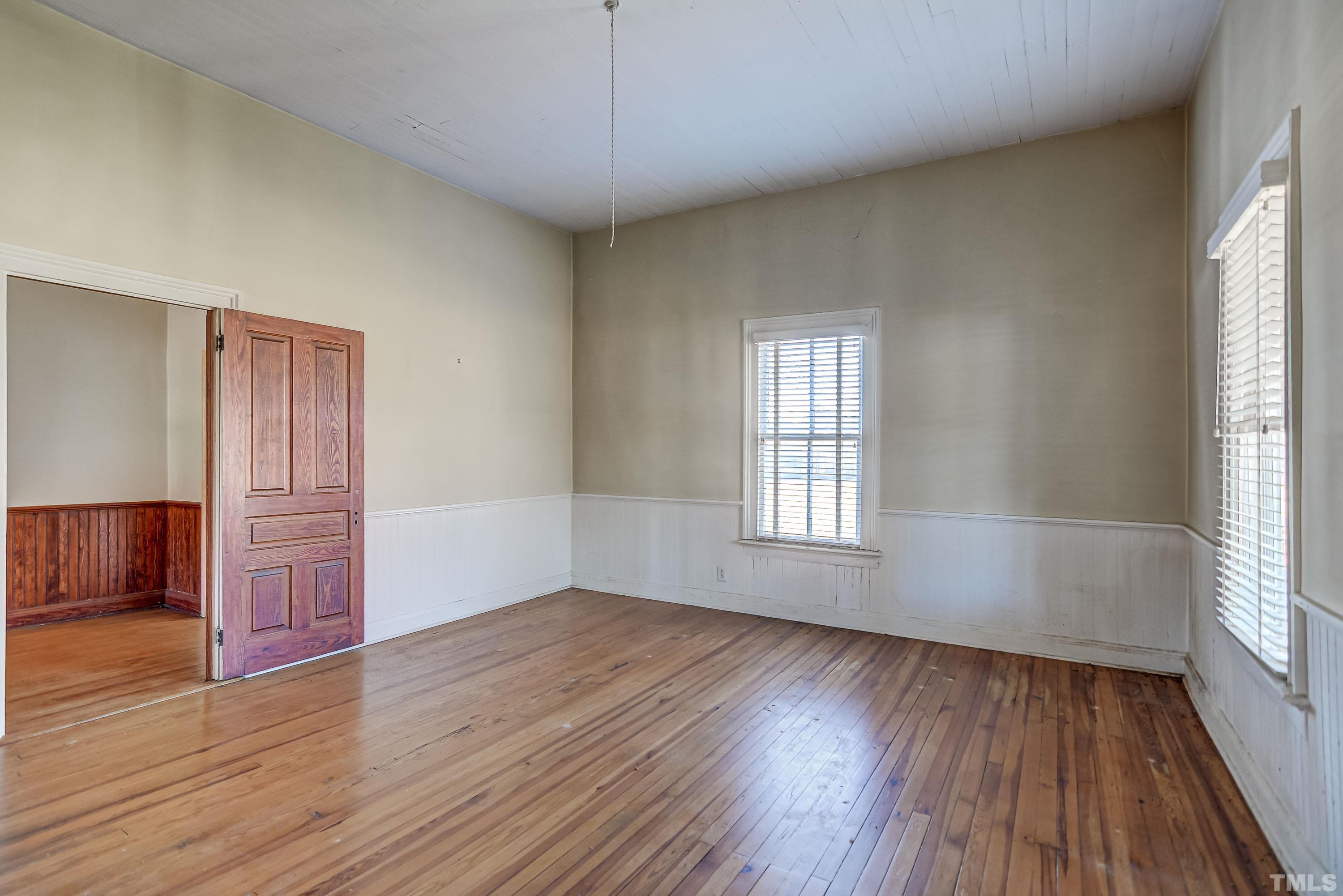 4740 Auburn Knightdale Road Raleigh, NC 27610 - Photo 21 of 23 an empty room with wooden floor and windows