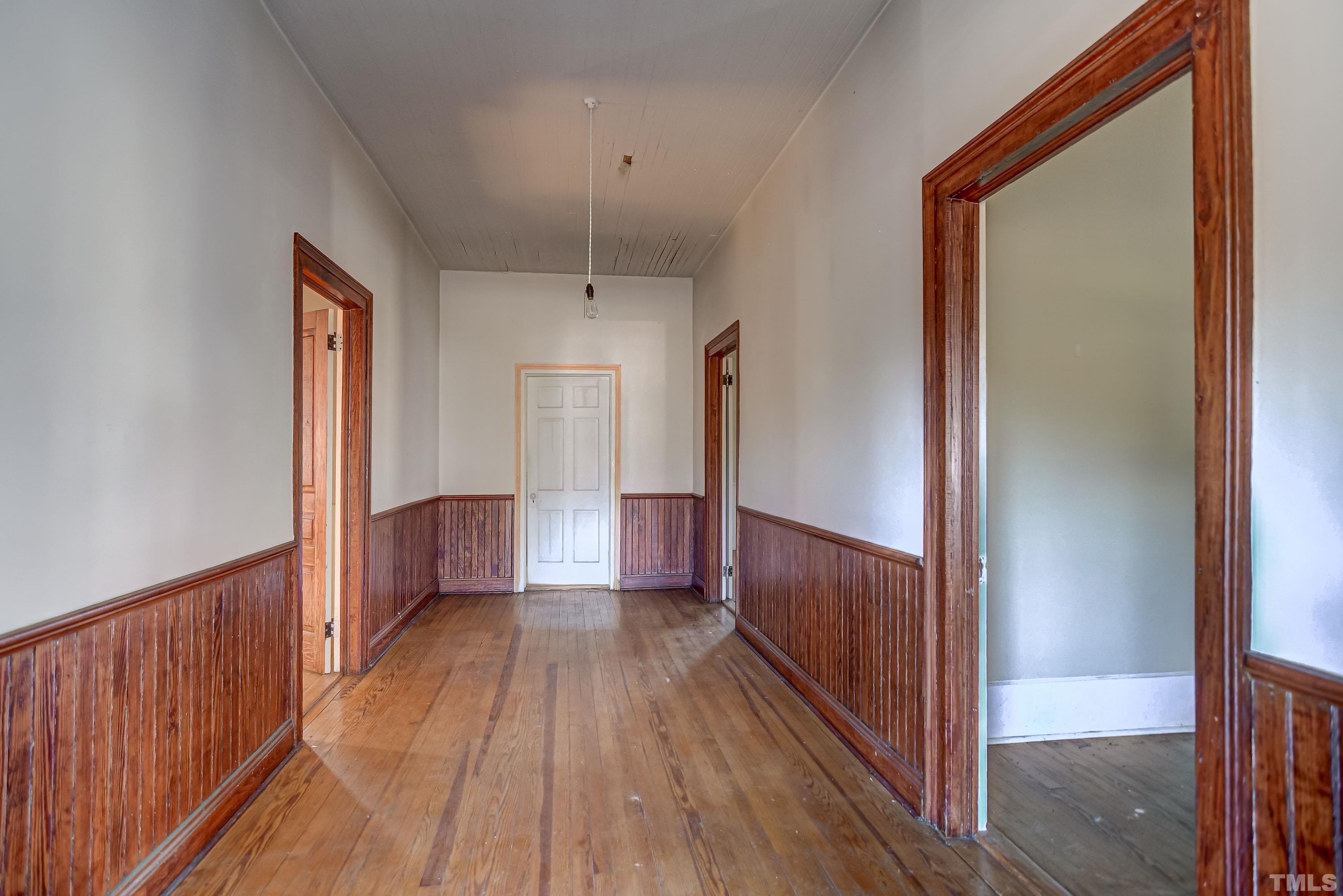4740 Auburn Knightdale Road Raleigh, NC 27610 - Photo 23 of 23 a view of a hallway with wooden floor