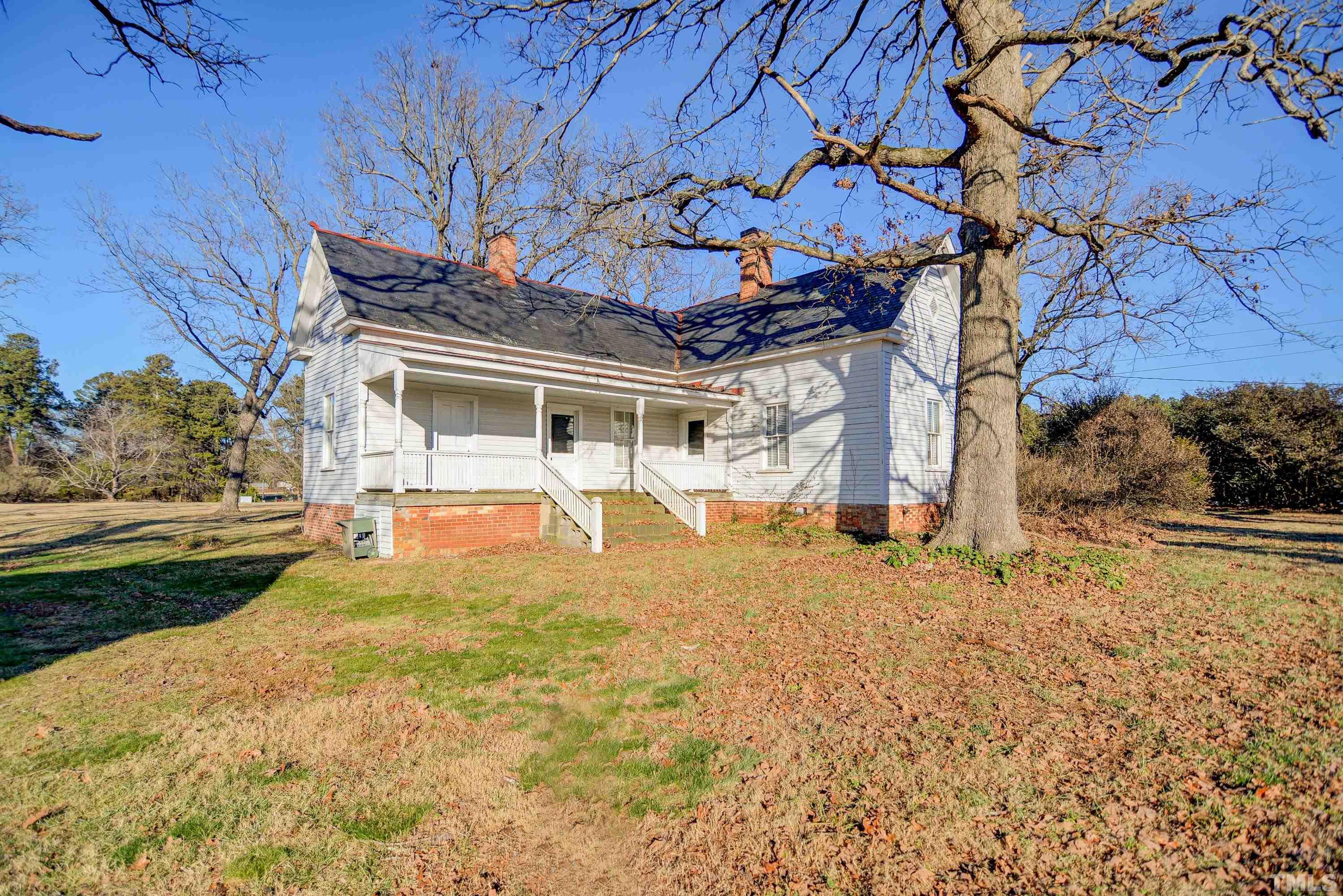 4740 Auburn Knightdale Road Raleigh, NC 27610 - Photo 5 of 23 a view of house with backyard and trees