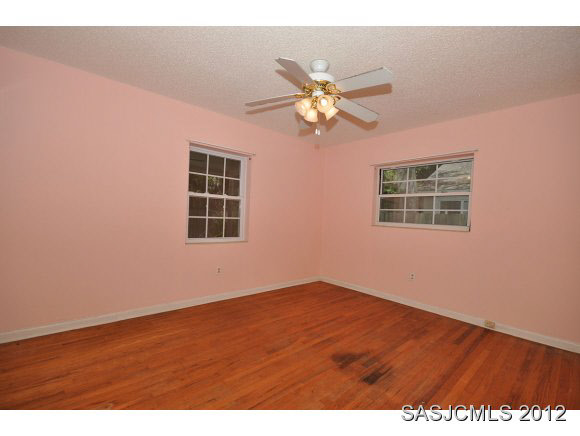 526 Jasmine Road St. Augustine, FL 32086 - Photo 8 of 18 an empty room with wooden floor closet and fan