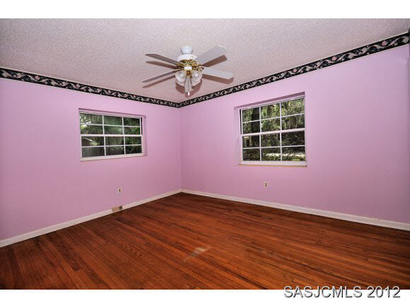 526 Jasmine Road St. Augustine, FL 32086 - Photo 10 of 18 a view of an empty room with a window and wooden floor