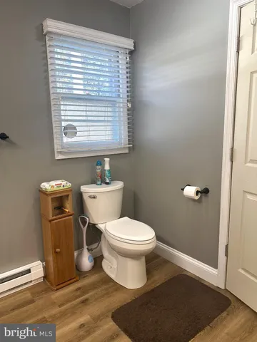 a bathroom with a toilet a sink and a window