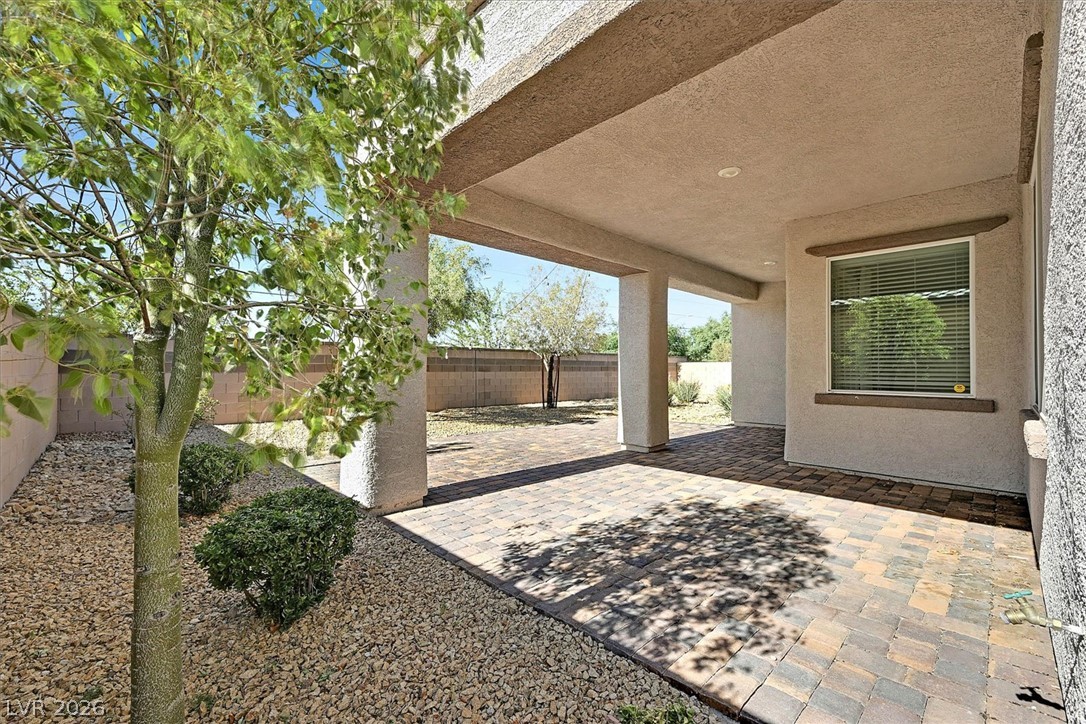 1106 Langston Ranch Avenue Henderson, NV 89002 - Photo 33 of 36 A spacious covered patio with paver flooring extends the living space outdoors, perfect for enjoyment.