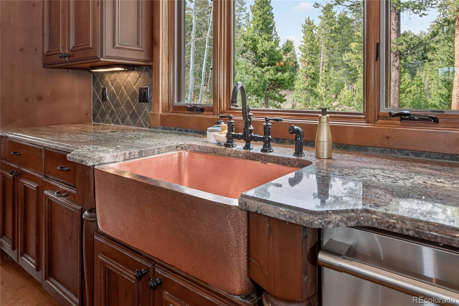 148 County Road Tabernash, CO 80478 - Photo 5 of 45 a kitchen with granite countertop a sink and a window