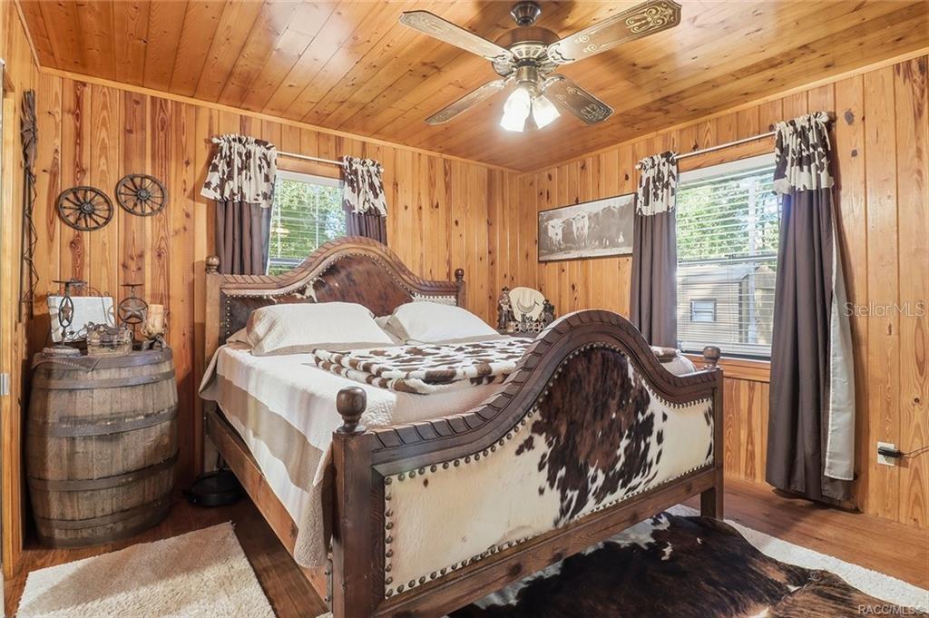 8110 Southwest 88th Lane Trenton, FL 32693 - Photo 16 of 29 a bedroom with a bed and a mirror