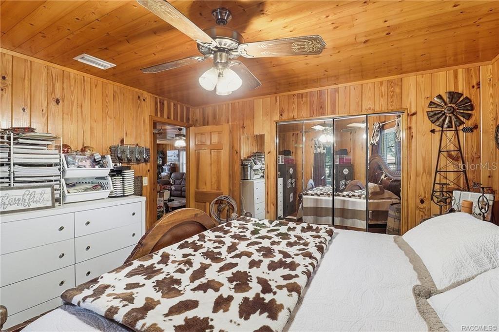 8110 Southwest 88th Lane Trenton, FL 32693 - Photo 17 of 29 a large bedroom with a large bed and a chandelier