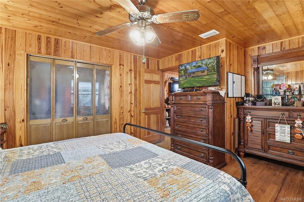 8110 Southwest 88th Lane Trenton, FL 32693 - Photo 20 of 29 a bedroom with a bed and wooden floor