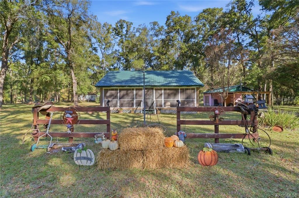 8110 Southwest 88th Lane Trenton, FL 32693 - Photo 2 of 29 a view of a patio with chairs and plants