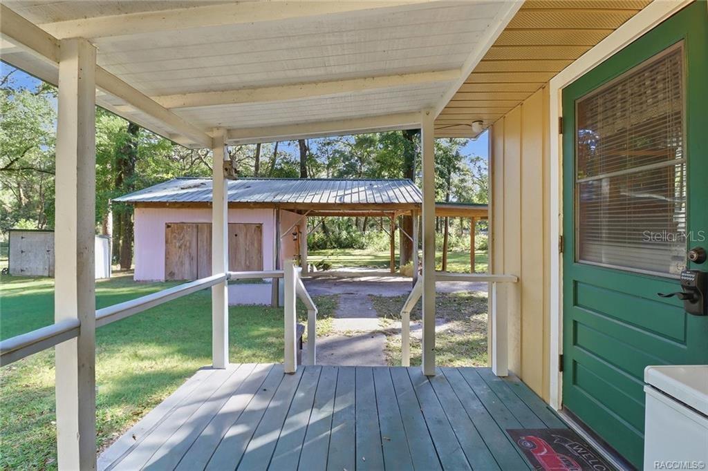 8110 Southwest 88th Lane Trenton, FL 32693 - Photo 22 of 29 a view of a porch with furniture and garden