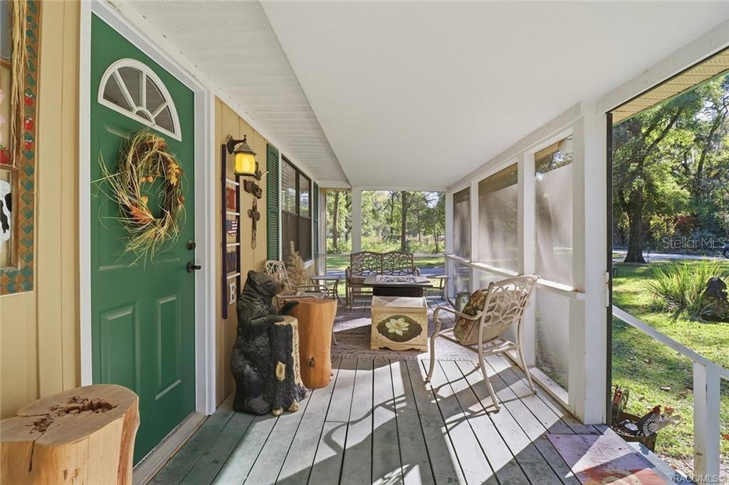 8110 Southwest 88th Lane Trenton, FL 32693 - Photo 4 of 29 a view of a balcony with chairs and a table