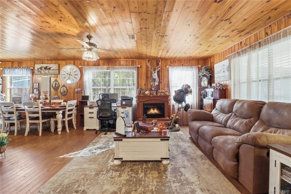 8110 Southwest 88th Lane Trenton, FL 32693 - Photo 8 of 29 a living room with furniture a fireplace and large windows
