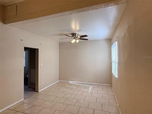 a view of a livingroom with a ceiling fan and window