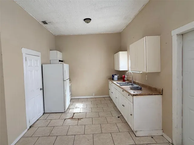 a kitchen with a cabinets and a stove top oven