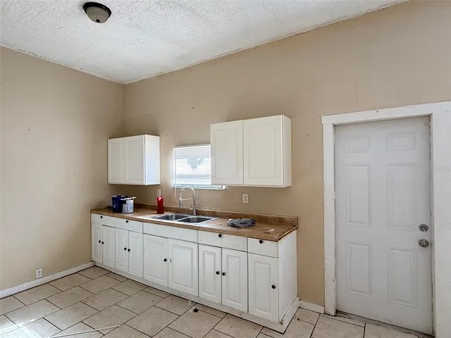 a room with cabinets and sink