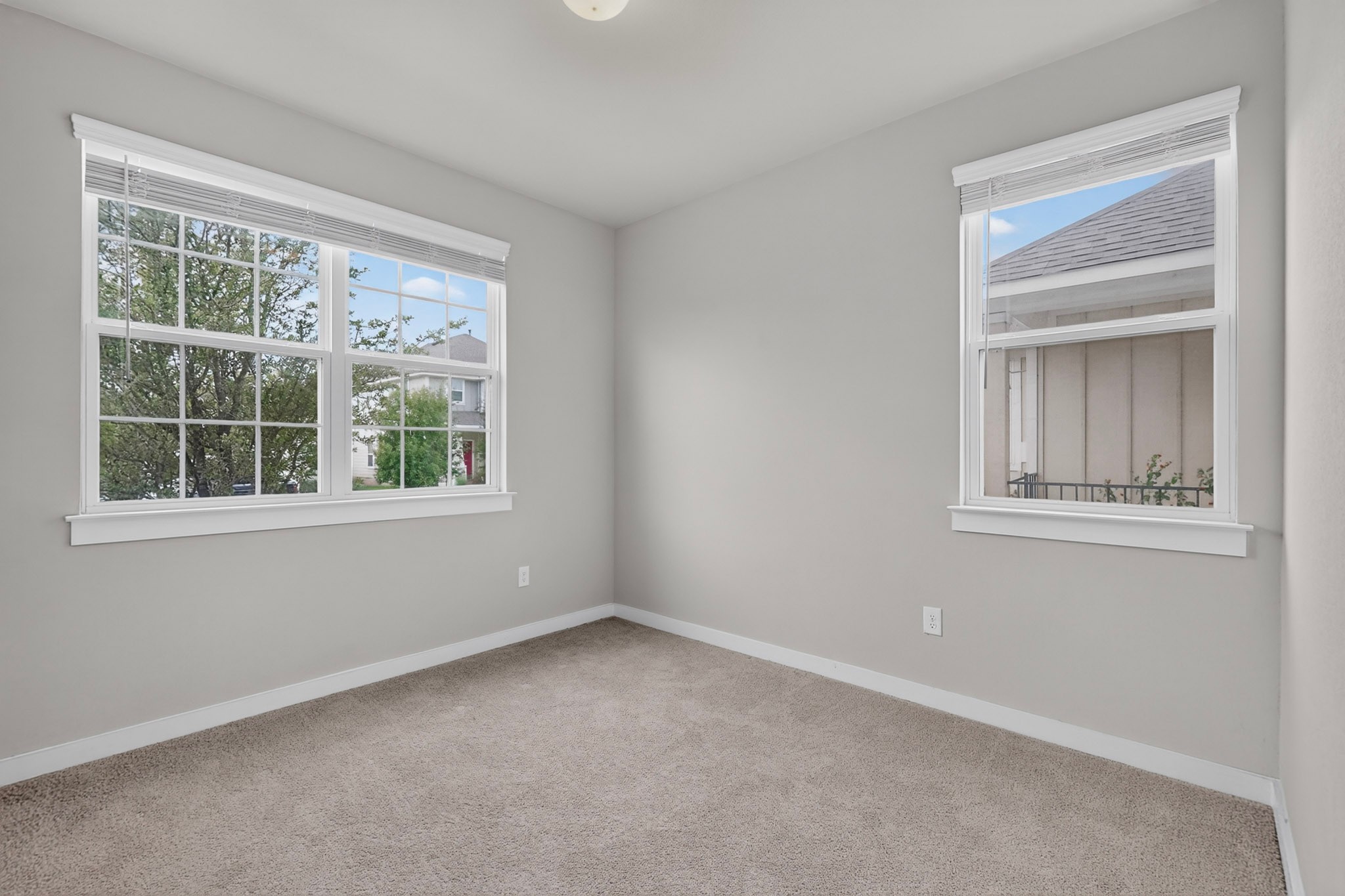 116 Appleberry Lane Elgin, TX 78621 - Photo 25 of 35 Well-lit room featuring ample natural light through multiple windows, complemented by plush carpeting.